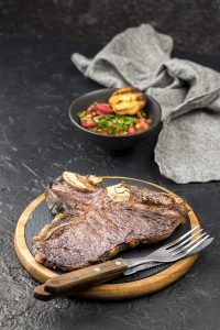 high angle steak with salad cutlery