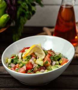 salad tomatoes cucumbers onions greens table